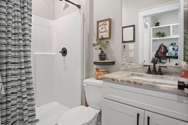 bathroom featuring vanity, toilet, and a shower with shower curtain