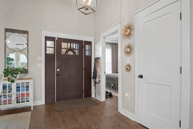 foyer featuring dark hardwood / wood-style flooring and a chandelier