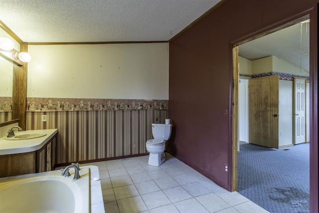 bathroom featuring tile patterned flooring, ornamental molding, and a textured ceiling