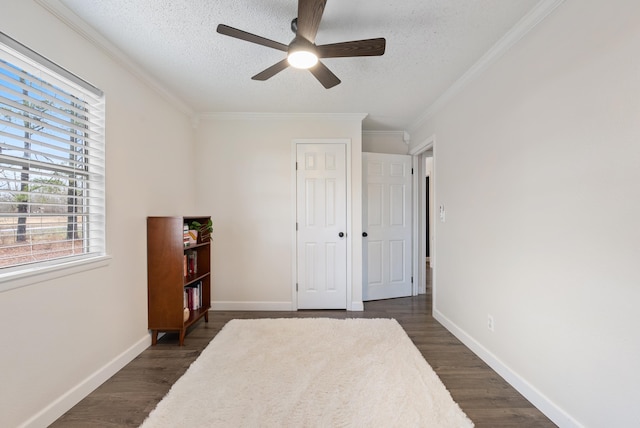 bedroom featuring crown molding, dark hardwood / wood-style floors, ceiling fan, and a textured ceiling