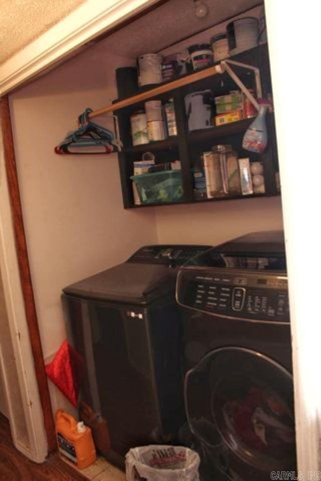 clothes washing area featuring independent washer and dryer