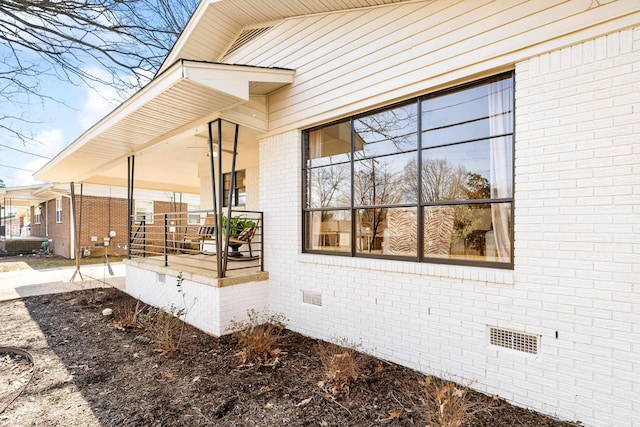 view of side of property with covered porch