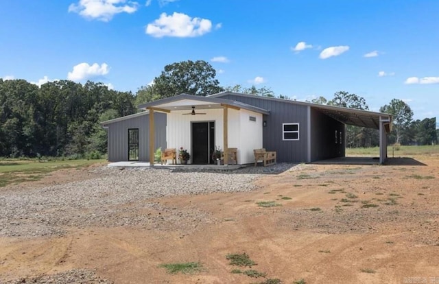 exterior space featuring ceiling fan and a carport