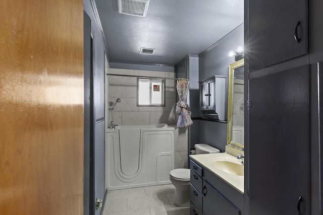 bathroom featuring vanity, toilet, and a textured ceiling