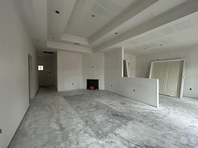 unfurnished living room featuring a tray ceiling