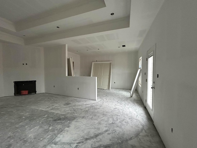 unfurnished living room with a raised ceiling