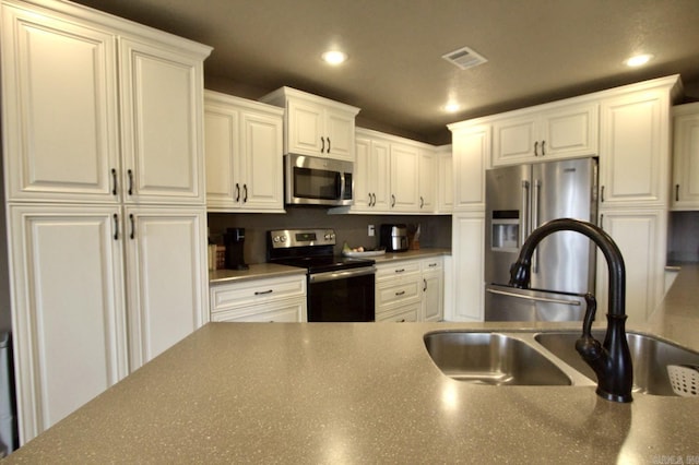 kitchen with white cabinetry, sink, and appliances with stainless steel finishes