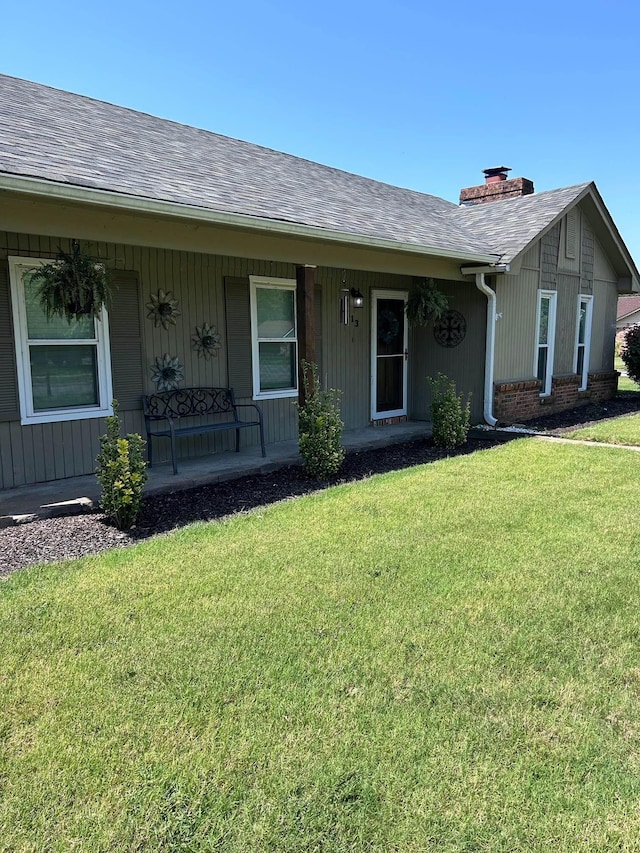 view of front of home with a porch and a front lawn