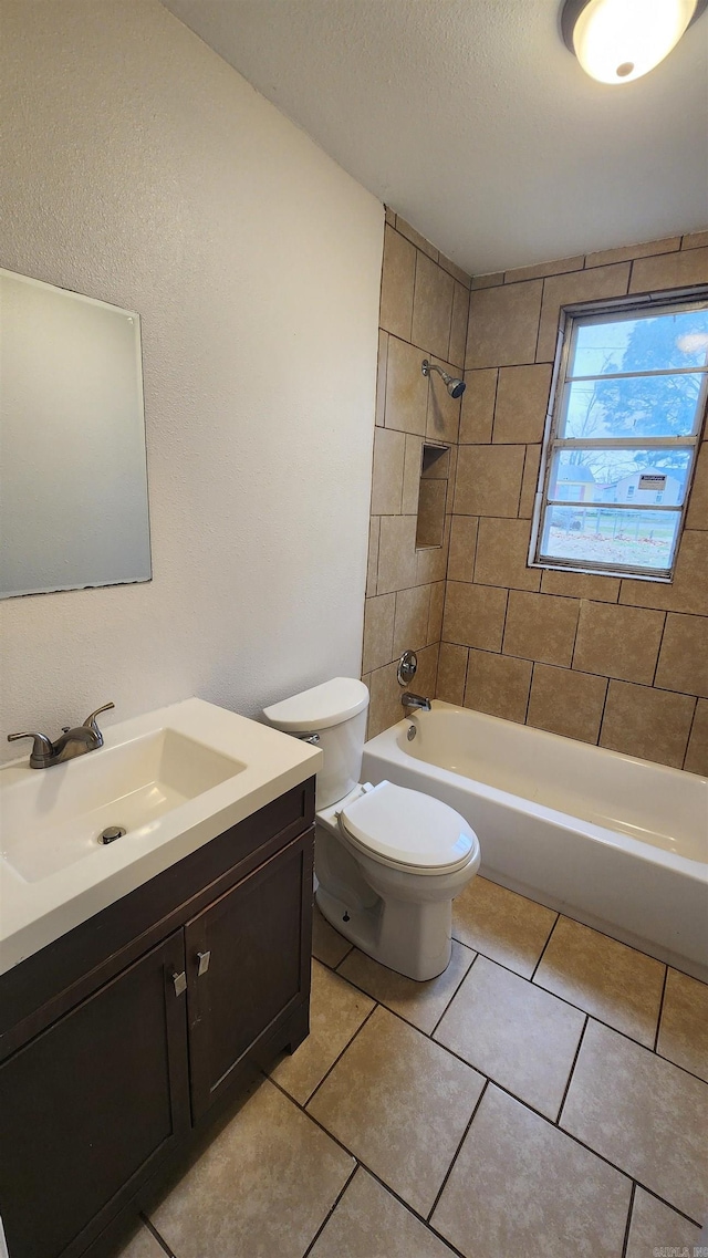 full bathroom with a textured ceiling, toilet, tile patterned floors, vanity, and shower / tub combination