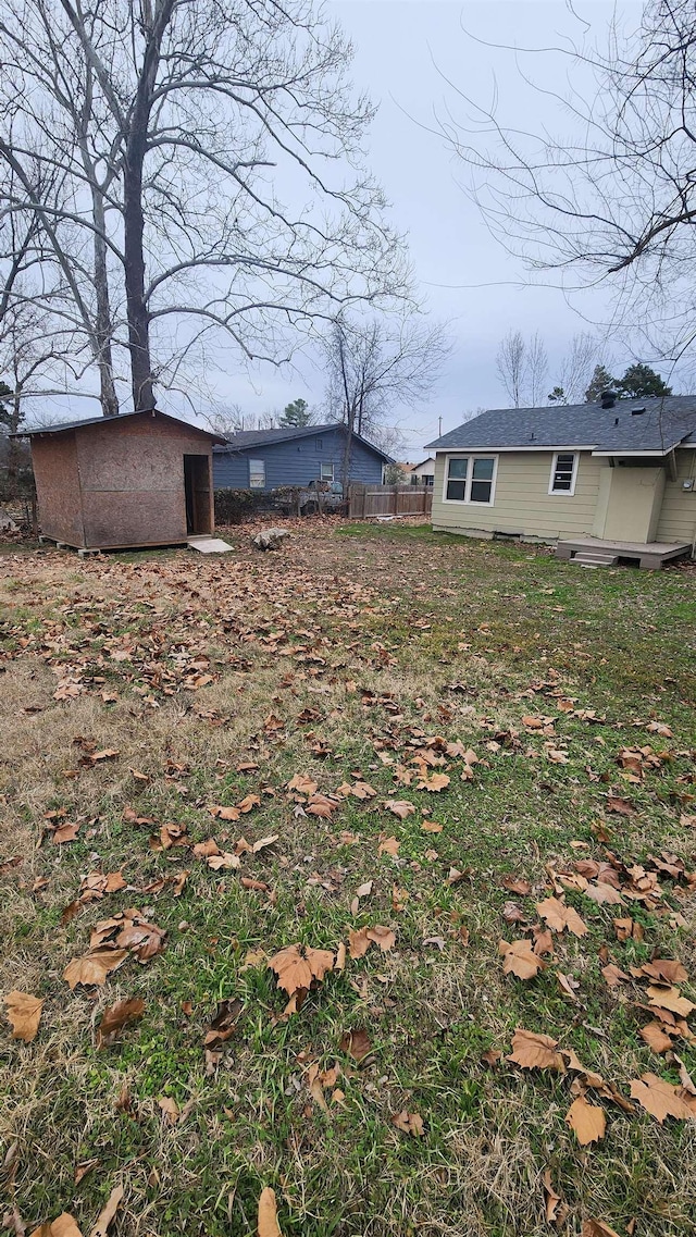 view of yard featuring an outbuilding and fence