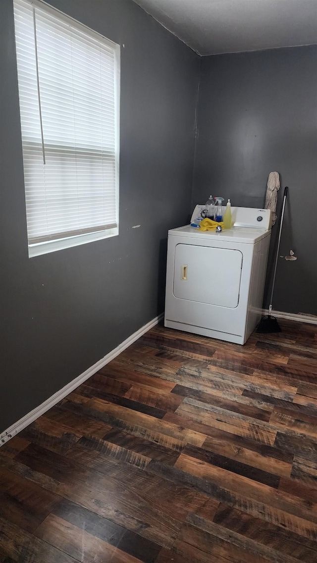 laundry area with baseboards, washer / clothes dryer, laundry area, and dark wood-style flooring