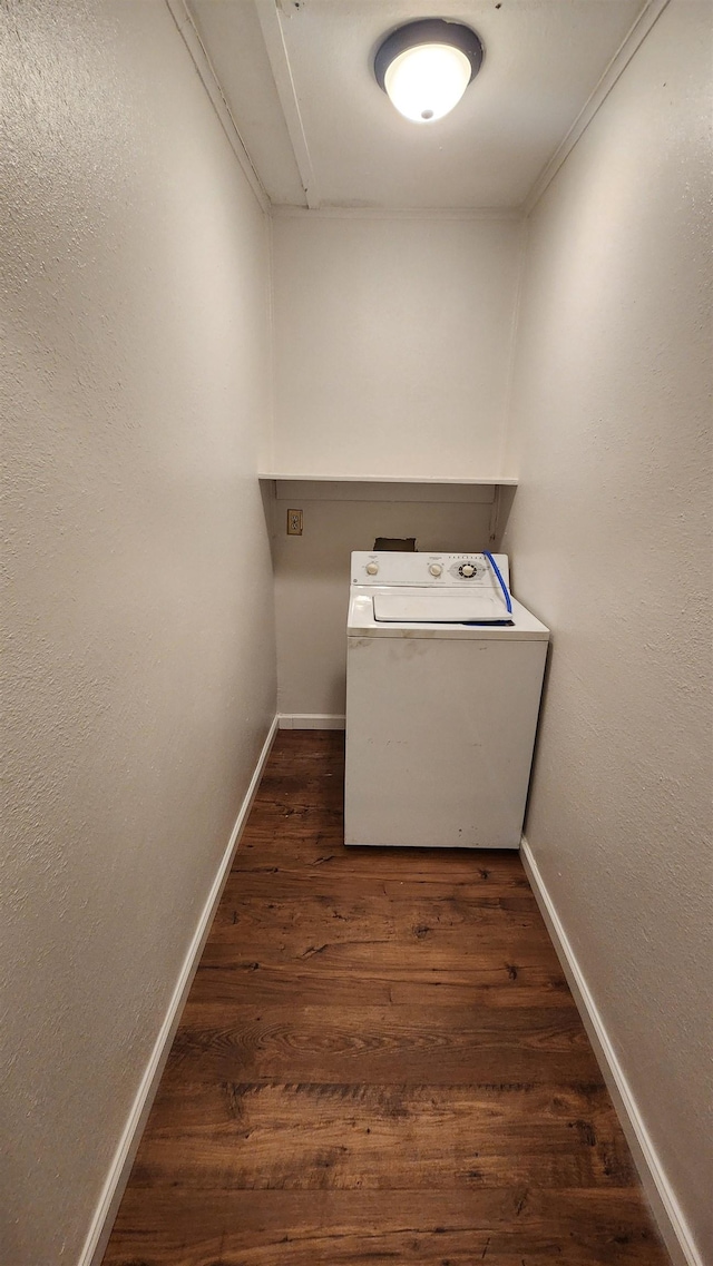 laundry area featuring baseboards, laundry area, washer / dryer, and dark wood-style flooring