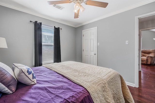 bedroom with dark hardwood / wood-style flooring, crown molding, and ceiling fan