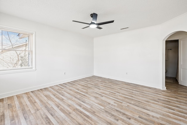 empty room featuring ceiling fan, a textured ceiling, and light hardwood / wood-style flooring