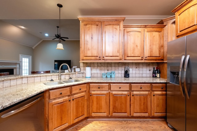 kitchen featuring sink, tasteful backsplash, ornamental molding, stainless steel appliances, and light stone countertops