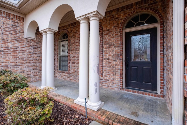 view of exterior entry featuring a porch