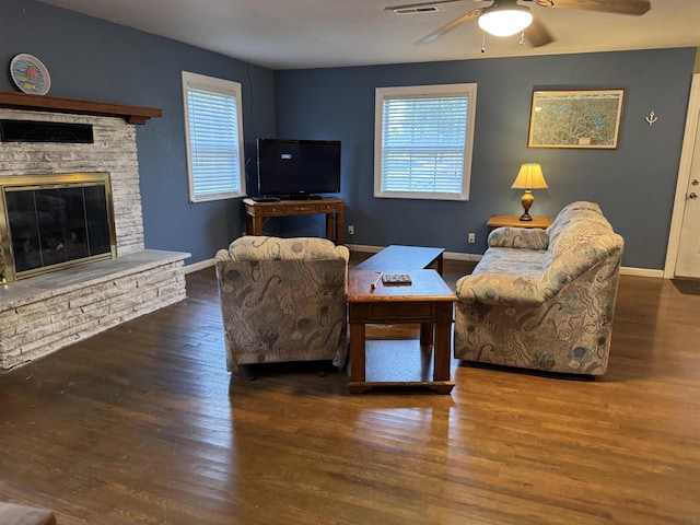 living room with a fireplace, dark hardwood / wood-style floors, and a wealth of natural light