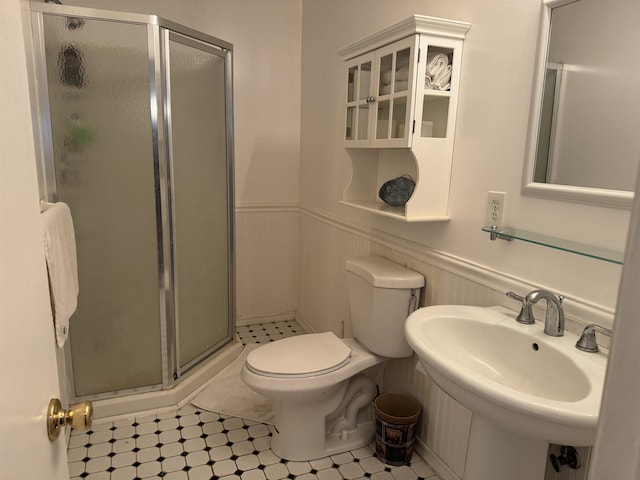 bathroom featuring toilet, sink, and walk in shower