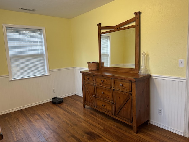 bedroom featuring multiple windows and dark wood-type flooring