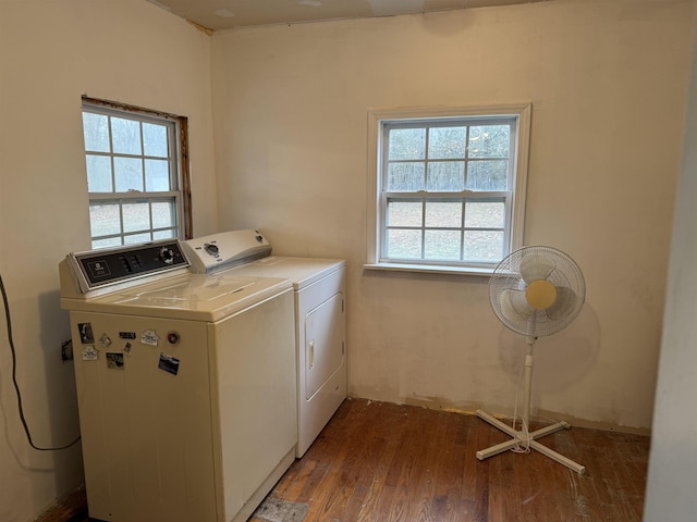 laundry room with hardwood / wood-style flooring, a wealth of natural light, and washer and dryer