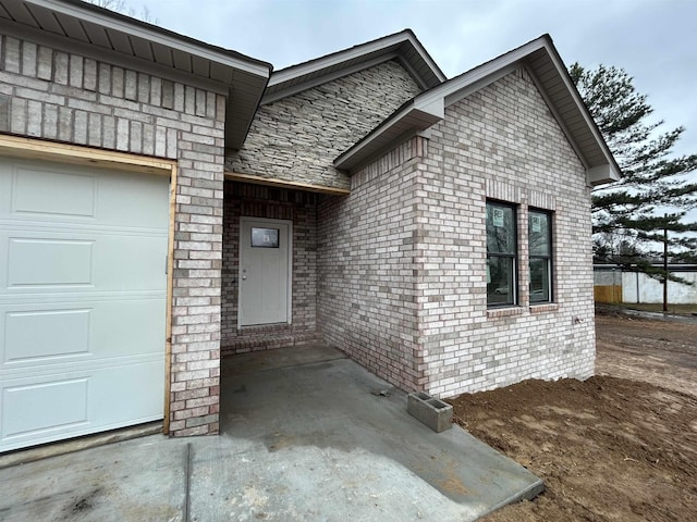 doorway to property with a garage