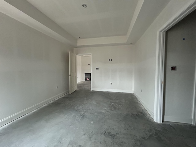 spare room with a tray ceiling