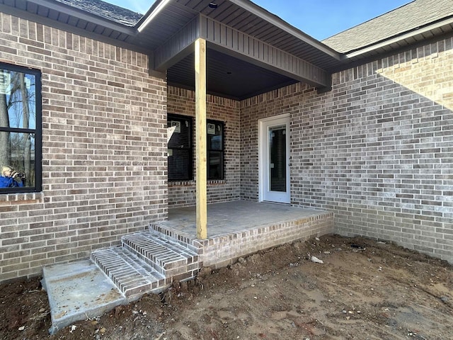 view of exterior entry featuring a patio