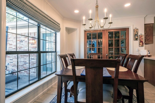 dining area with ornamental molding, a chandelier, and light tile patterned floors