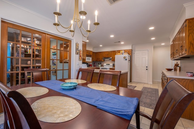 dining room with crown molding, light tile patterned flooring, a notable chandelier, and french doors