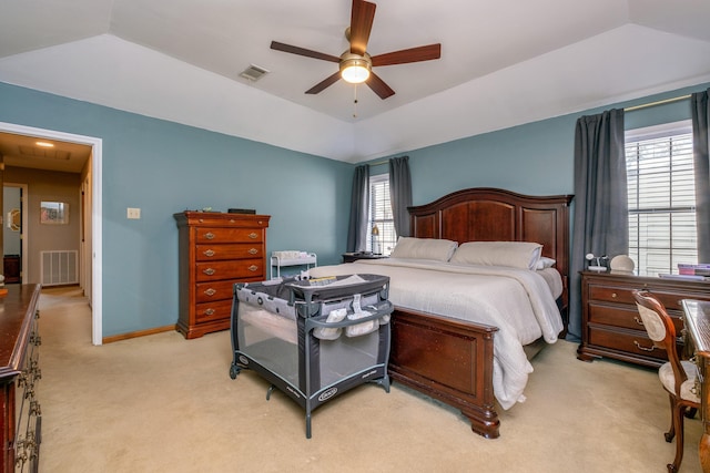 carpeted bedroom featuring ceiling fan, a tray ceiling, and vaulted ceiling