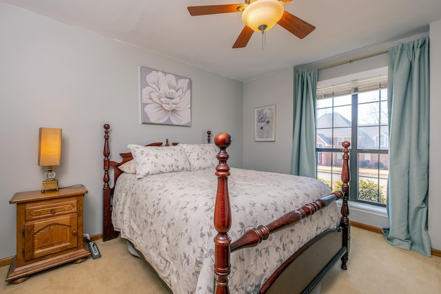 bedroom with light colored carpet and ceiling fan