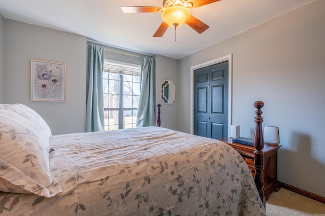 carpeted bedroom with ceiling fan and a closet