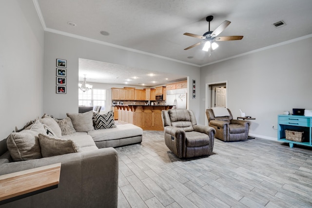 living room featuring crown molding, ceiling fan with notable chandelier, a textured ceiling, and light wood-type flooring