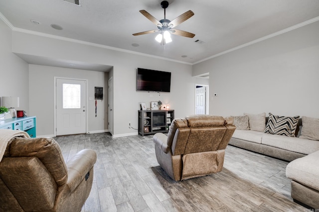 living room with ceiling fan, ornamental molding, and hardwood / wood-style floors