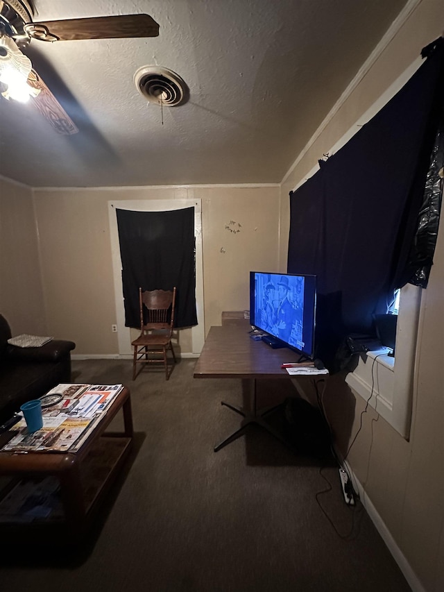 carpeted living room with ceiling fan and a textured ceiling