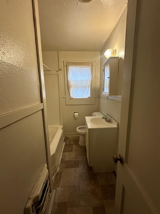 full bathroom with vanity, shower / bathtub combination, toilet, and a textured ceiling