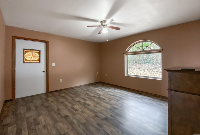 unfurnished room featuring dark hardwood / wood-style floors and ceiling fan