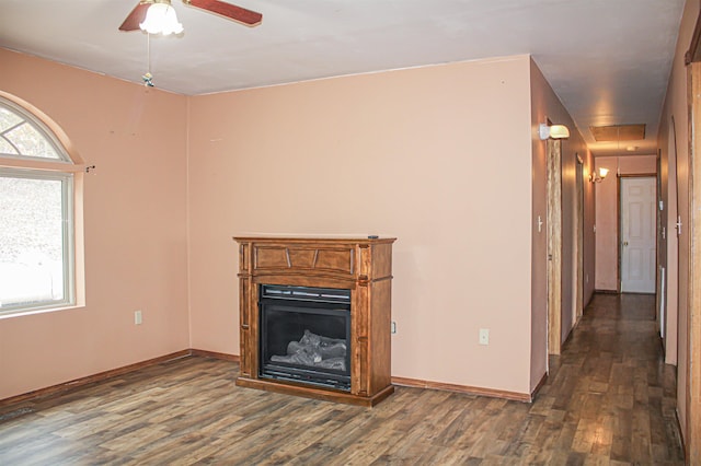 unfurnished living room with dark wood-type flooring and ceiling fan