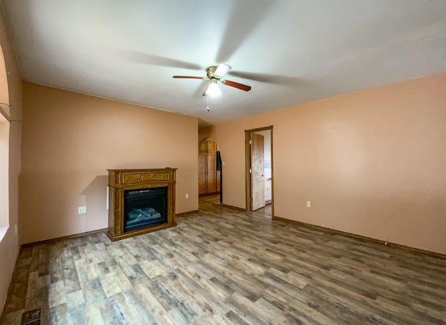 unfurnished living room with ceiling fan and light hardwood / wood-style floors