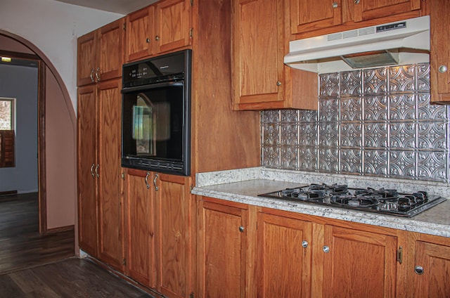 kitchen featuring dark hardwood / wood-style floors and black appliances