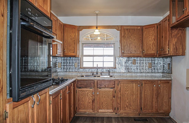 kitchen with decorative light fixtures, tasteful backsplash, sink, oven, and stainless steel gas cooktop