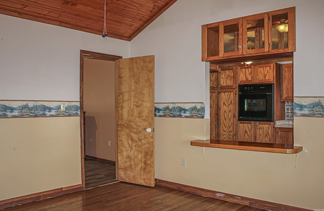 interior space featuring vaulted ceiling, black oven, dark hardwood / wood-style flooring, and wood ceiling