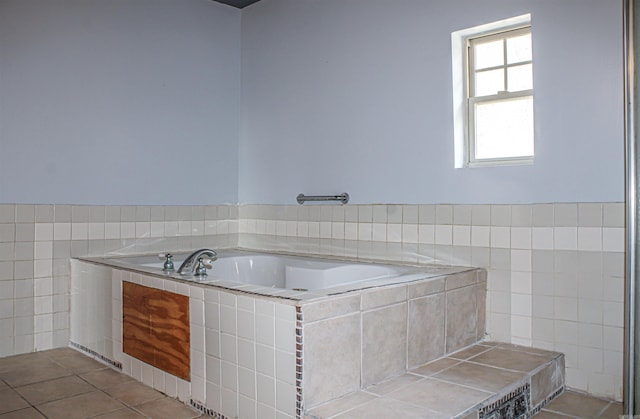 bathroom featuring tile walls, tile patterned floors, and tiled bath