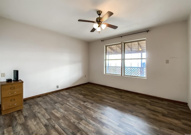 empty room with dark wood-type flooring and ceiling fan