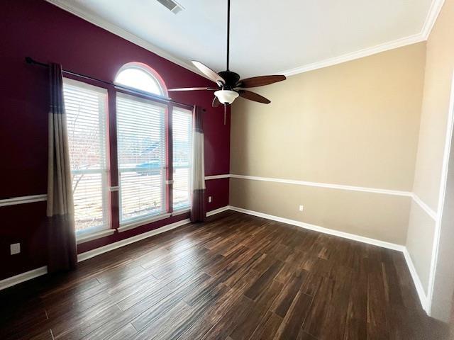 spare room with dark hardwood / wood-style flooring, crown molding, and ceiling fan