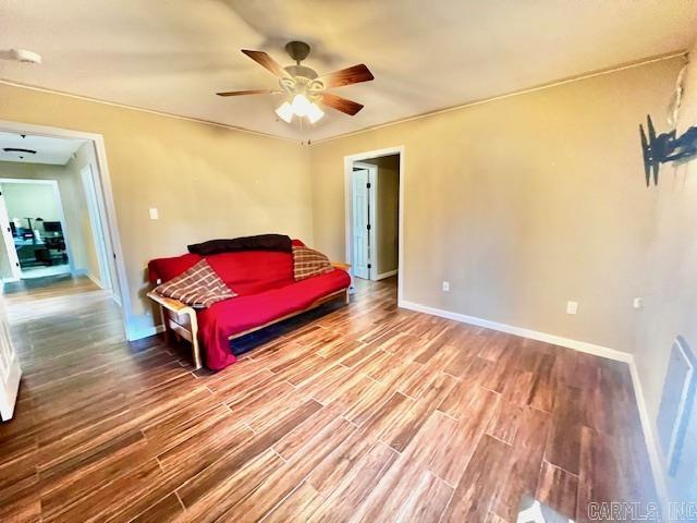 bedroom with hardwood / wood-style flooring and ceiling fan