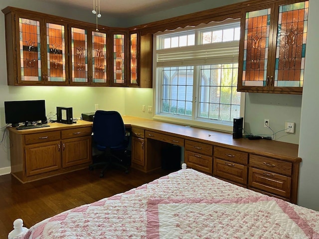 bedroom featuring dark hardwood / wood-style floors and built in desk