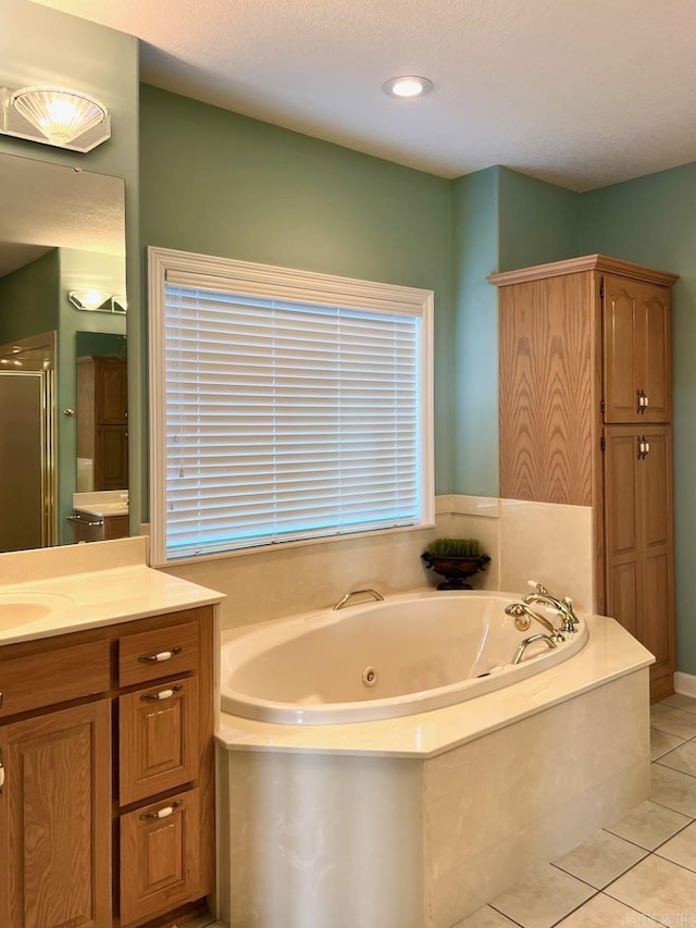 bathroom featuring vanity, plus walk in shower, tile patterned flooring, and a textured ceiling