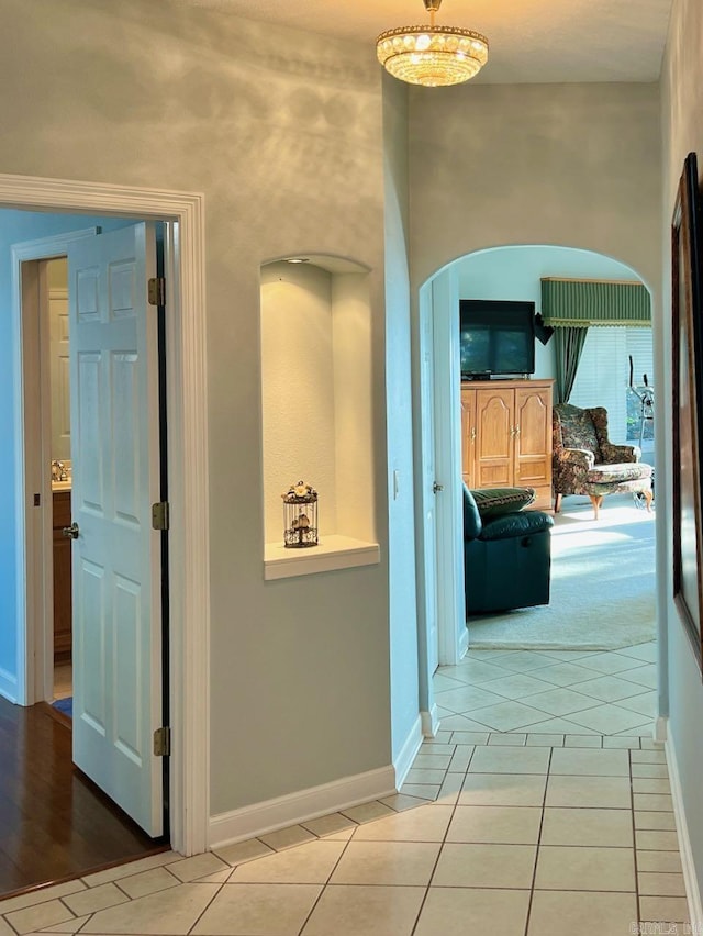 hall featuring light tile patterned flooring