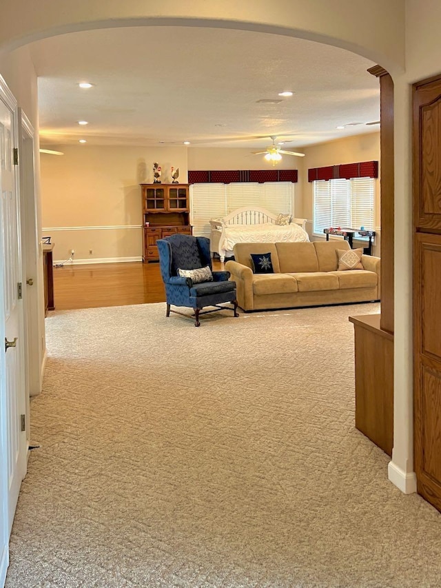 living room featuring ceiling fan and light carpet